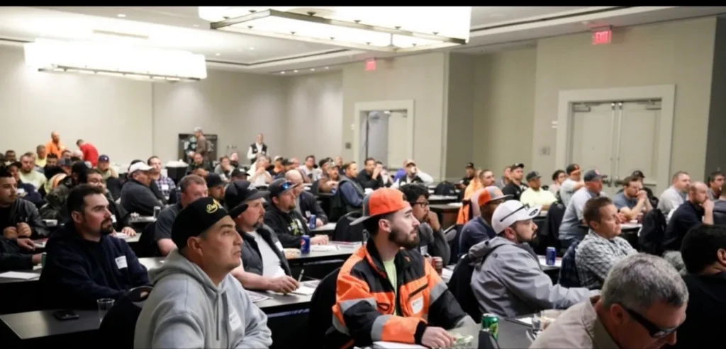 Packed room of field leaders listening to Mark Breslin