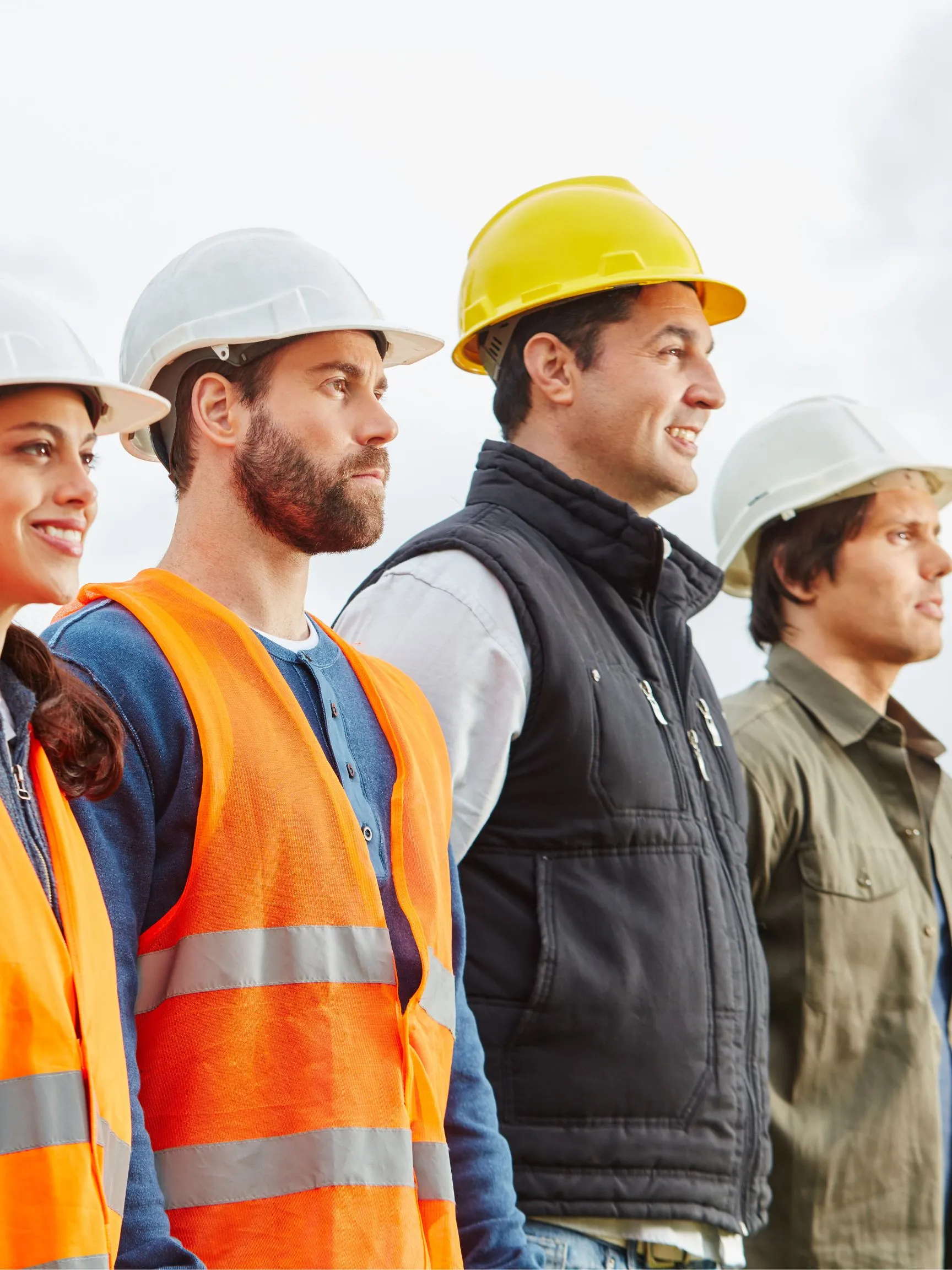 Four construction field leaders in hardhats